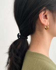 Irregular C-Shaped Stud Earrings worn on an adult model