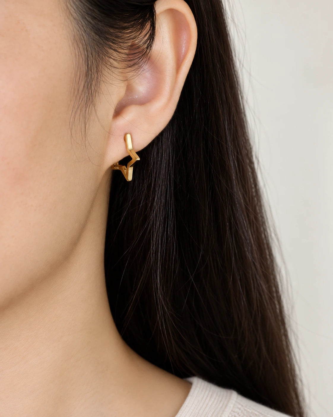 Open Star Hoop Earrings worn on an adult model