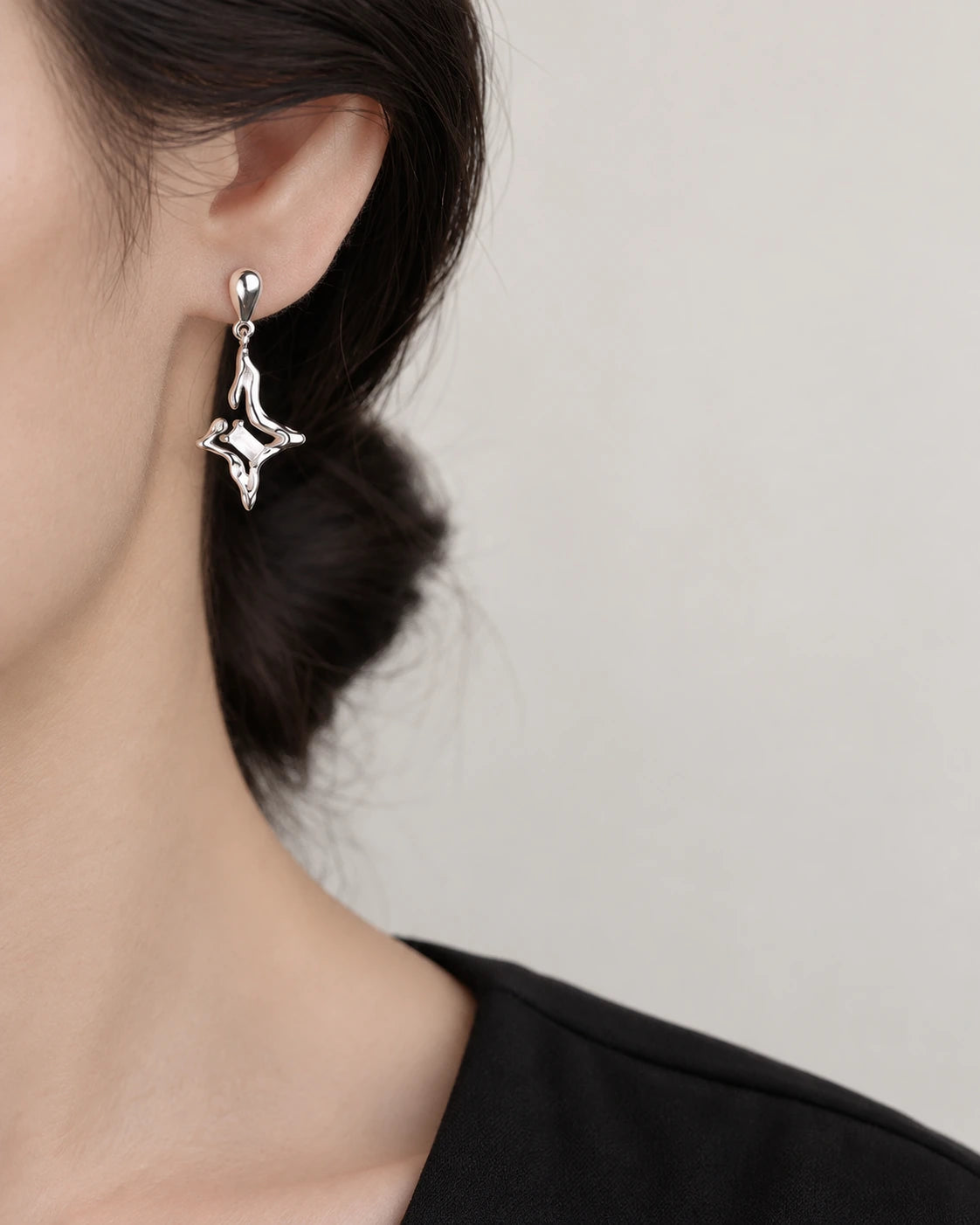 Star Drop Earrings worn on an adult model
