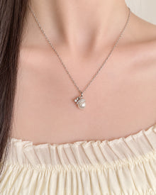 Santa Hat Pearl-Look Pendant Necklace worn on an adult model
