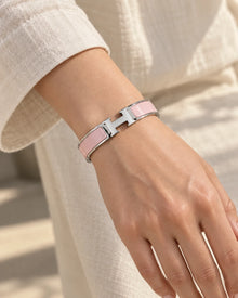 Signature H-Clasp Bangle – Minimalist & Secure Lock Bracelet, Everyday Luxury (Silver / Pink) worn on wrist with H-shaped clasp