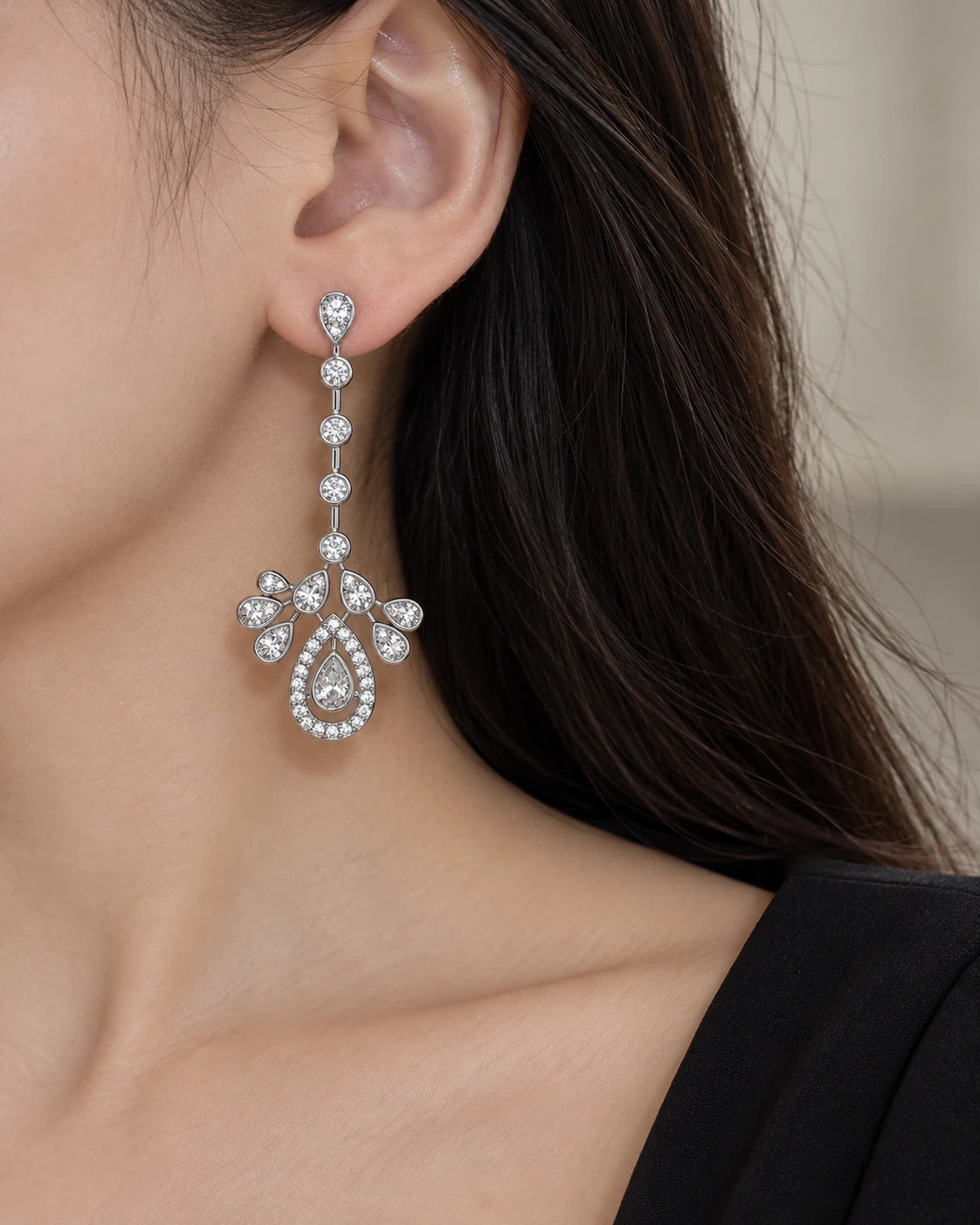 Teardrop CZ Chandelier Earrings with Crown Detail worn on an adult model